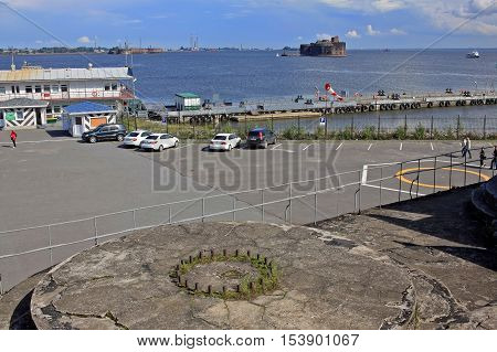 Kronstadt Russia - July 10 2016: View of the Fort Alexander (Plague Fort) and a pier from Fort Constantine. The forts of Saint-Petersburg is a complex of permanent fortifications at different times built to protect the capital from attack from the sea.