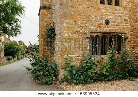Stanton UK - August 17 2015: Delightful corner of a typical limestone house in the center of the village. It is one of the prettiest and idyllic villages in the Cotswolds.