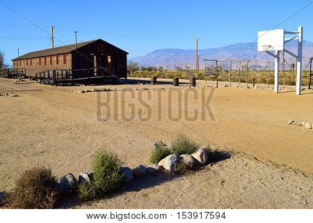 Replica housing building beside a basketball court where Japanese Americans were forced to stay during World War 2 taken at Manzanar War Relocation Camp near Independence, CA