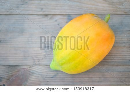 Yellow papaya organic on a wooden floor.