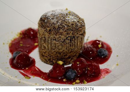 Tasty poppy-seed cake garnished with cream - close-up