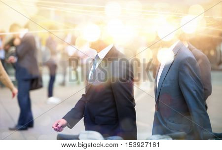 Business people walking in the City, blurred image with lights reflection. Business and modern life concept