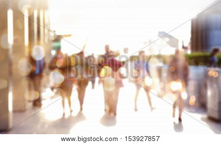 Business people walking in the City, blurred image with lights reflection. Business and modern life concept