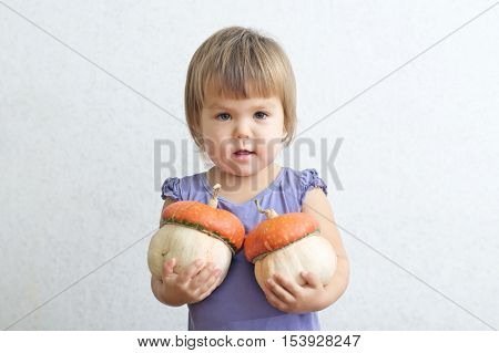 Little Child Girl With Two Decorative Pumpkins