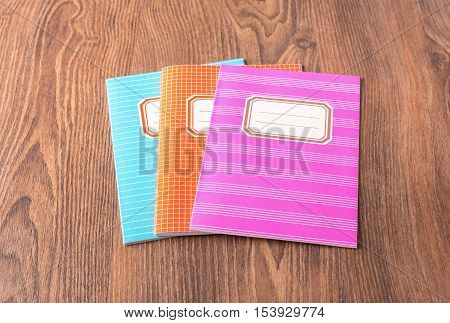 Colored Exercise Books On The Blue Wooden Background