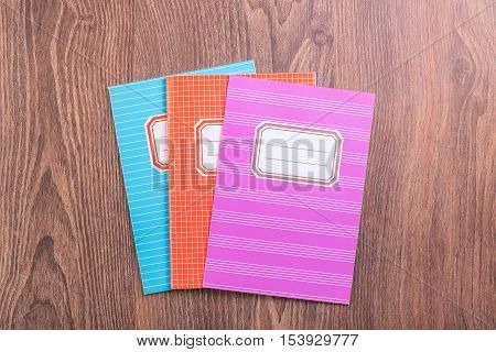 Colored Exercise Books On The Blue Wooden Background