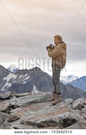 Male Model Posts From The Top Of Snowcapped Mountain Peak Around Aoraki Mount Cook And Mount Cook Na