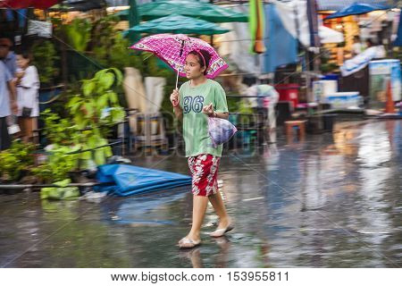 People In Blurred Motion At  At  Chatuchak  Weekend Market In Rain