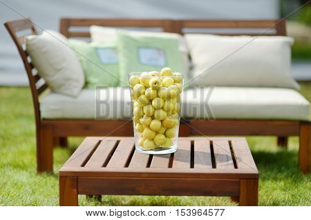 Vase Full Of Peaches On A Wooden Table
