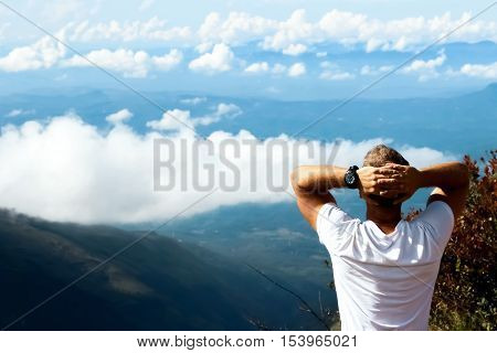 Man relaxes on the edge of the cliff . Plateau 