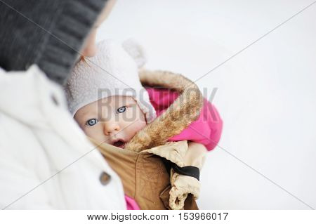 Young Mother And Her Little Baby In A Carrier