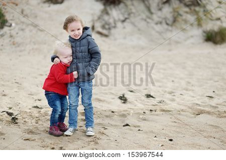 Twi Little Sisters At The Beach On Autumn