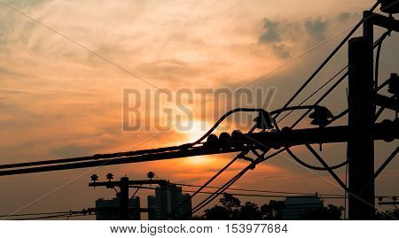 Electricity power plant and city concept - Electric pole in city with evening light and space for text