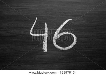 number forty six enumeration written with a chalk on the blackboard