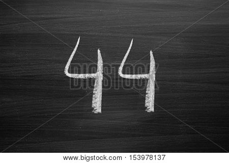 number forty four enumeration written with a chalk on the blackboard