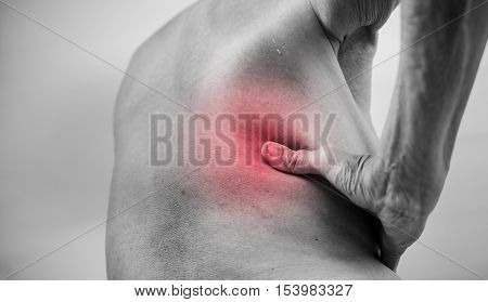 senior man hand holding he back and massaging in pain area. Concept with Healthcare And Medicine