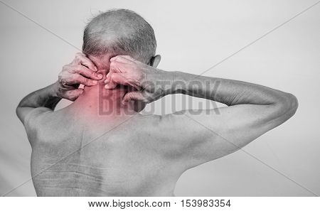 senior man hand holding he neck and massaging in pain area. Concept with Healthcare And Medicine with red effect with red effect.