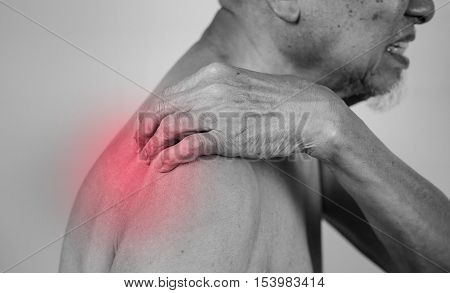senior man holding he shoulder on pain area with red effect