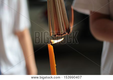 Chinese pay respect to ancestorst,Placing a lighted candle and lit for descendants
using on good folkway. Selective focus.