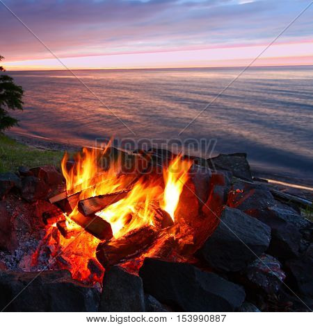 Sunset camp fire along the beautiful beach of Lake Superior in northern Michigan.
