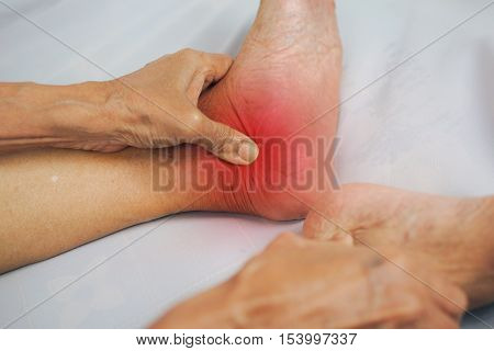 senior man hand holding he healthy foot and massaging ankle in pain area