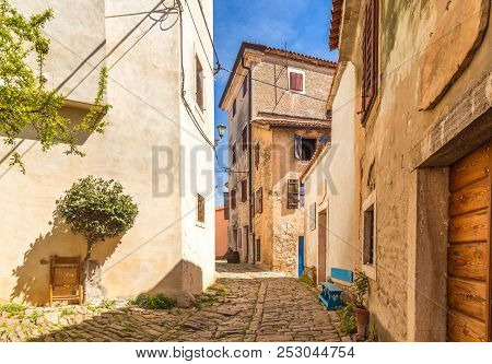 Ancient Colorful Houses On A Stone Street In Groznjan Village, Istria, Croatia, Europe.