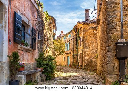 Ancient Colorful Houses On A Stone Street In Groznjan Village, Istria, Croatia, Europe.