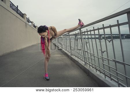 Attractive And Strong Woman Stretching Before Fitness And Lake In The Summer. Sports Concept. Health
