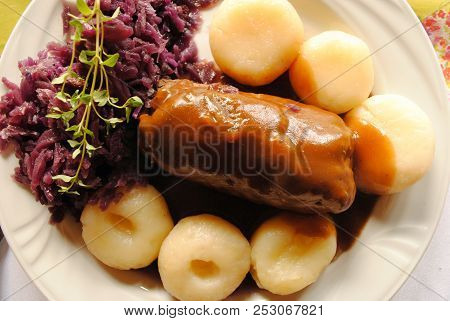 Traditional Polish Dish - A Meat Roll With Kluski And Stewed Cabbage