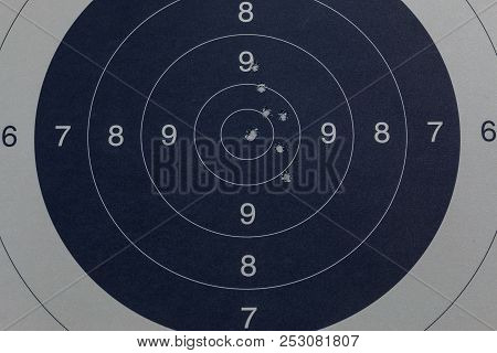 Bullet Holes In The Black Target By A Gun