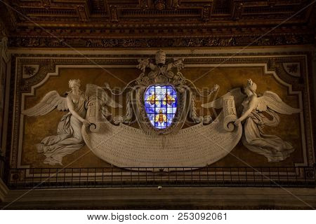 Rome, Italy - September 12, 2017: Stained Glass Window And Bas-relief In Basilica Of Santa Maria In 