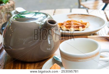Tea Pot, Mug And Belgian Waffle For Breakfast Are Set On Wooden Table For A Lovely Day