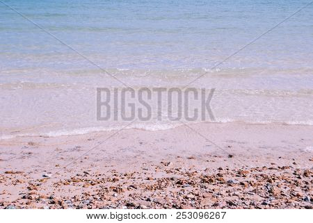 Soothing Sea And Rock Beach, Has Some Little Wave In Sunny Day
