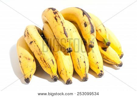 Golden Yellow Ripped Banana With Some Stains Isolated On White Background And Strong Light