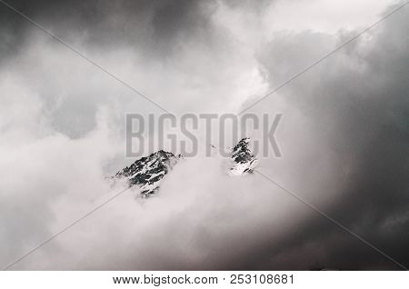 Snow-covered Mountains Of The Himalayas In The Clouds At The Height Of