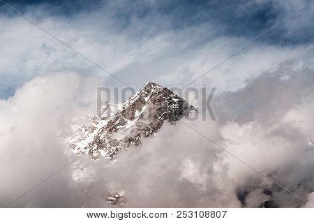 Snow-covered Mountains Of The Himalayas In The Clouds At The Height Of