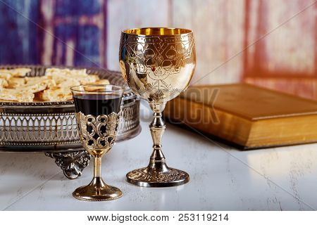 Holy Communion On Wooden Table On Church. Cup Of Glass With Red Wine, Bread On Wooden Table And Holy