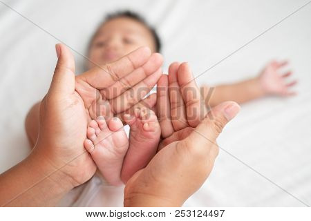 Newborn Baby Feet On Female Hands, Shape Like A Lovely Heart, Baby Feet In Mother Hands. Mom And Her