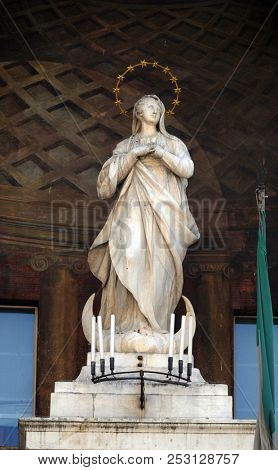 MODENA, ITALY - JUNE 04: Virgin Mary statue on Clock tower, Modena town Hall on Piazza Grande, a UNESCO World heritage site, Modena, Italy on June 04, 2017.