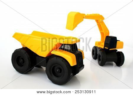 Isolated Toy Truck And Toy Escavator In Yellow And Black Colors With White Background
