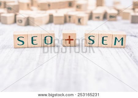 The Words Seo And Sem Formed By Wooden Blocks On A White Table