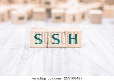The Word Ssh Formed By Wooden Blocks On A White Table