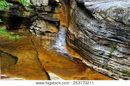 Ozark Mountain Cascade Tumbles Through A Cleft In A Rocky Ledge In Arkansas.