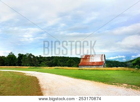 Solitary, Tin Barn Sits At The Edge Of The Mountain Overlooking The Ozarks In Arkansas.