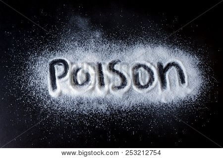 Salt Scattered On Black Surface. Written Word- Poison. Concept- Healthy Food, Diet, Harm To Health F