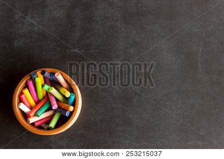 Bright Pastel Crayons Lie In A Ceramic Bowl On A Black School Board. Children's Creativity. Concept-