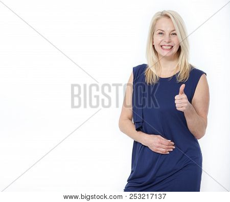 Happy Caucasian Female Wearing Dress Making Thumb Up Sign And Smiling Cheerfully, Showing Her Suppor
