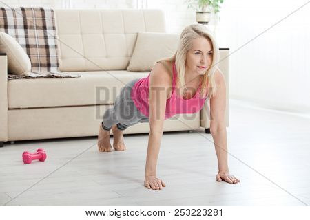 Working With Your Body. Full Length Of Beautiful Middle Aged Woman In Sportswear Doing Plank While S