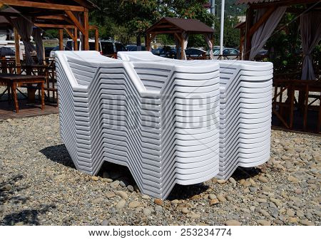 Sun Loungers In A Stack Folded. New Chaise Lounges.