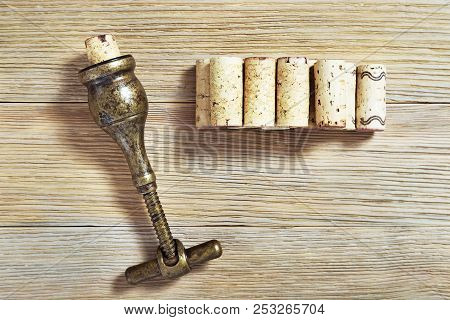 Wine Corks Close Up, Plugs Of The Wine Bottle, Metal Corkscrew On Old Wood. Vintage Background For W